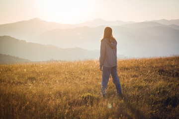 Pretty Teen Girl Walking in Mountain Sunrise Landscape