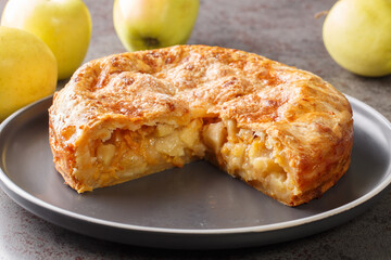 American freshly apple cheddar cheese pie closeup in the plate on the table. Horizontal