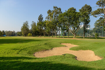 Fototapeta premium A sand bunker in a golf course on a clear day