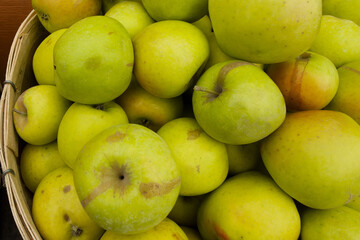 green apples in a bushel basket