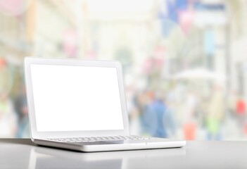 Fototapeta premium Laptop displaying a blank screen on the desk