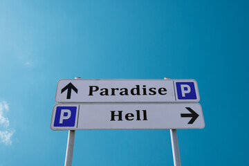 Fototapeta premium Decision analysis. Road signs with the inscriptions Paradise and Hell against a clear blue sky.