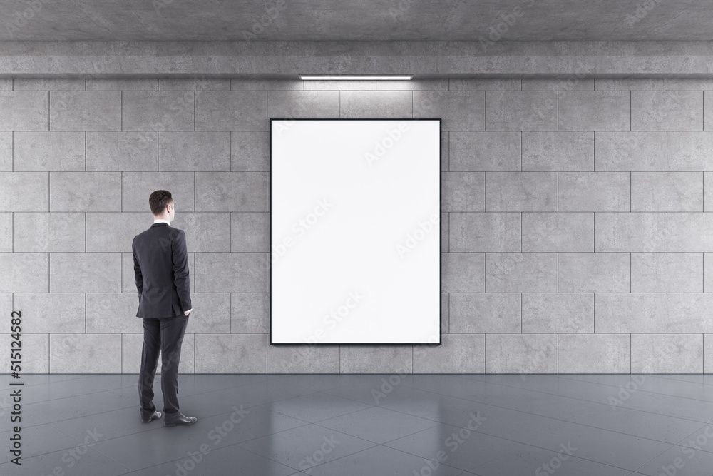 Poster advertising concept with businessman back view looking at blank white poster in black frame with spa