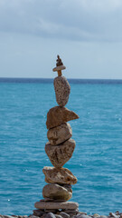 The art of rest, relaxation and meditation and placing the stones carefully in a perfect balance. A tall pile of stones placed in equilibrium and above all a statue of Buddha.