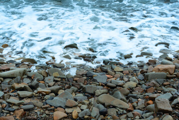 Nature background with sea waves hitting the sea shore. Scenic view of sea against cloudy sky