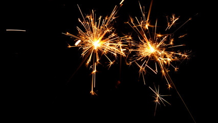 sparkler celebrating new year at night on black background