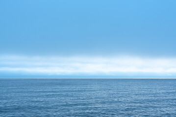 Nature background with blue sea against cloudy sky