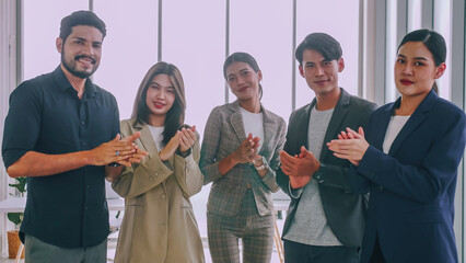 A group of colleagues are clapping their hands in congratulations. Successful business team...