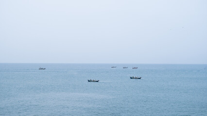 Fototapeta na wymiar Fishing boats in the middle of a ocean in gokarna Karnataka