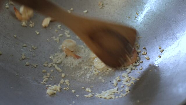 frying fresh shrimp with chopped garlic in pan preparing for cooking padthai street food