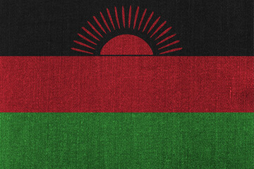 Patriotic classic denim background in colors of national flag. Malawi