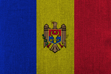 Patriotic classic denim background in colors of national flag. Moldova