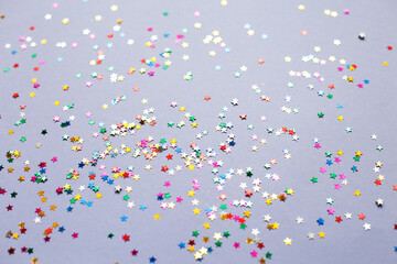 multicolor sparkles on a purple background. Festive backdrop for your projects.