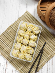 Frozen Dimsum (Siomay or Shumai) on Clear Plastic Container, usually package with Spicy Sauce....