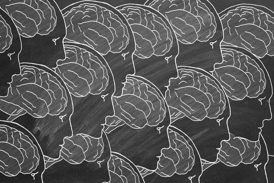 Human Heads and Brain. Hand drawn Illustration on blackboard. The concept of human creativity and collective mind. Idea, Analysis, Brainstorm, Success.