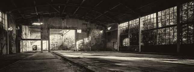 Old abandoned factory building or warehouse on sunny summer day