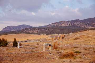 Ancient ruins of Amphitheater in Hierapolis city in Pamukkale Turkey sunset