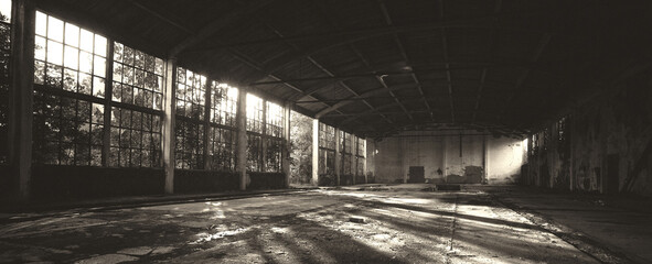 Old abandoned factory building or warehouse on sunny summer day