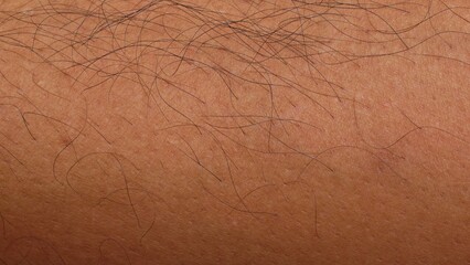 black human body hair on tan human skin background texture