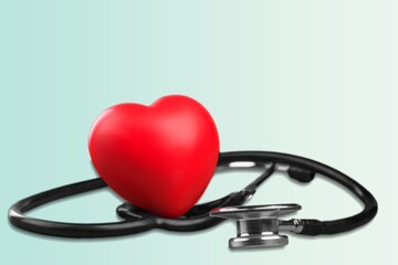Red heart shape hand exercise ball with doctor physician's stethoscope. World heart health day. doctor day, world hypertension day