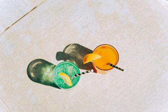Closeup shot of tropical sparkling lemonade cocktails. Gasses with orange and mint lemon fruit cocktails. Blank copy space picture of summer alcohol free drinks. Hello summer holiday vacation