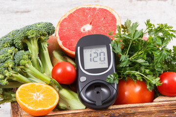 Glucometer with sugar level and natural fruits with vegetables. Diabetes and nutritious food containing minerals and vitamins