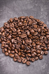 Heap of roasted fragrant coffee grains. Structure concrete