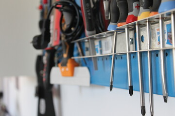Tools and screwdrivers hanging on the workshop wall
