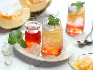 Es Blewah. Indonesian cold fruity drink of cantaloupe strips with syrup, basil seeds on top