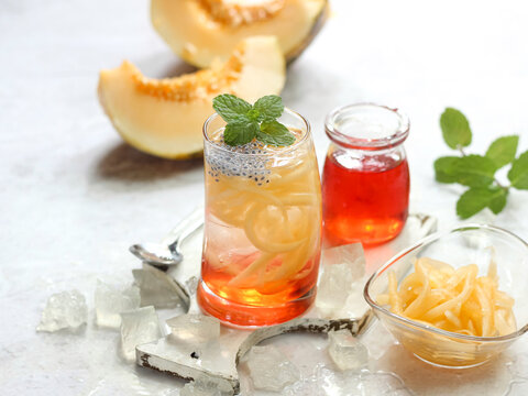 Es Blewah. Indonesian cold fruity drink of cantaloupe strips with syrup, basil seeds on top