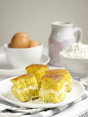 Martabak Keju, Indonesian Traditional Street Food Named Martabak Manis (Sweet Martabak) with Grated Cheese on WhiteTable. Selective focus