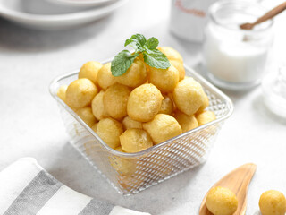 A bowl of Lokma (Turkish), loukoumades (Greeek ) with other names in other languages, are pastries made of leavened and deep fried dough. Selective focus