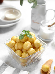A bowl of Lokma (Turkish), loukoumades (Greeek ) with other names in other languages, are pastries made of leavened and deep fried dough. Selective focus