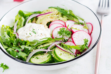 Vegetarian vegetable salad of radish, cucumbers, avocado and yogurt.  Healthy vegan food.