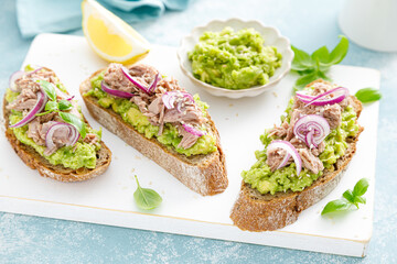 Toasts with canned tuna and avocado guacamole. Healthy food, diet breakfast