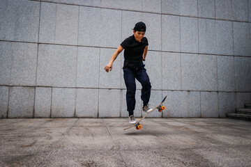 Asian woman skateboarder skateboarding in modern city