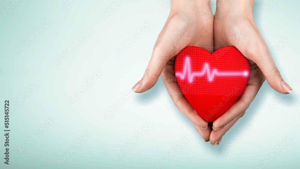 Wall mural World Hypertension Day. Adult holds a red heart with a heartbeat chart, a symbol of high blood pressure.