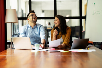 Fototapeta premium Colleagues in office. Businesswoman and businessman drinking coffee