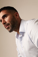 Sideways portrait of bearded brutal man on white background. Vertical mock-up.