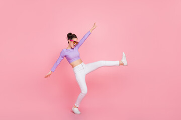 Fototapeta na wymiar Full length body size view of attractive cheerful crazy girl having fun moving rest isolated over pink pastel color background