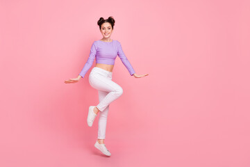 Fototapeta na wymiar Full body photo of satisfied overjoyed lady have fun jumping beaming smile isolated on pink color background