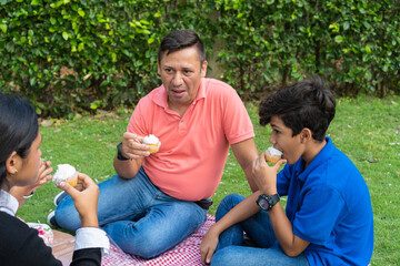 Family spending a day outdoors, having a picnic