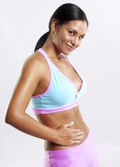 Fototapeta premium Latin woman touching her belly after training workout.