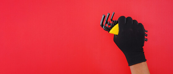 hand wearing white gloves holding Hexagon or allen wrenches or hex key on a red background,...