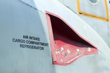 Air intake cargo compartment refrigerator decal on an old aircraft.