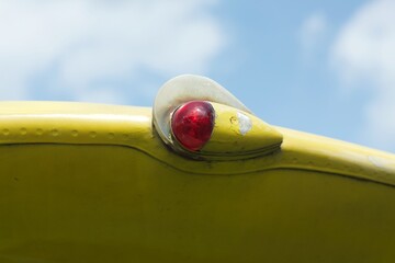 Red aviation navigation lights on yellow wing of an old aircraft