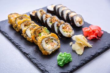 Sushi set grilled in tempura  on the stone plate