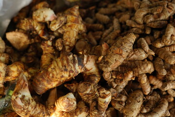 indonesian spices like ginger , turmeric, aromatic ginger, and galangal at traditional market