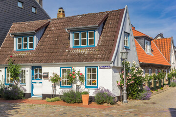 Little white house in Holm fishing village in Schleswig, Germany - obrazy, fototapety, plakaty