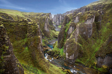 Beautiful canyon Fardrargljufur in Iceland. Canyon with green flora and blue water in tranquility.